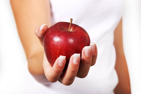 person holding apple