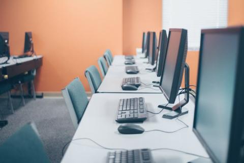 A row of computers on tables