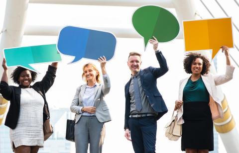 Group of people holding chat bubbles