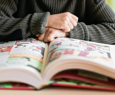 Young person reading a comic