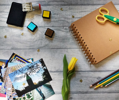 Photos, a flower, and various scrapbook supplies on a table