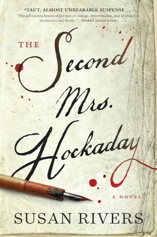 A fountain pen laying on a cream book cover with red ink dots splashed on it. Book title is The Second Mrs Hockaday by Susan Rivers.