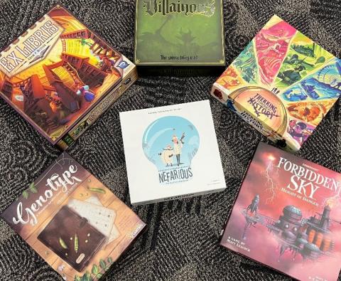 Photo of five board game boxes encircling a sixth board game box