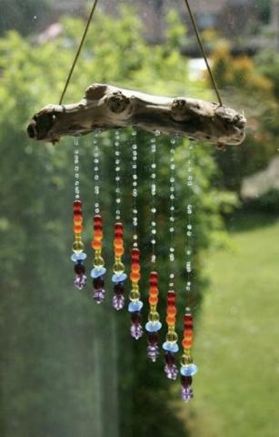 photograph of an arrangement of colorful beads hanging from a piece of wood