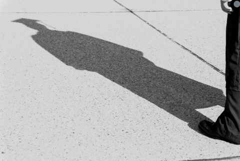 Shadow of student in graduation cap