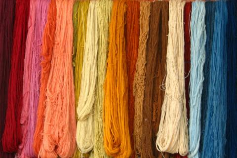 Hanks of dyed yarn hanging next to one another