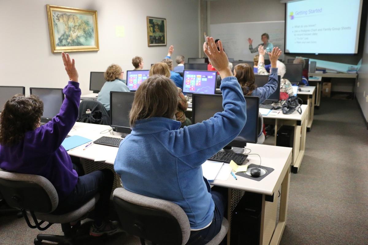 image of people in a computer lab with a teacher