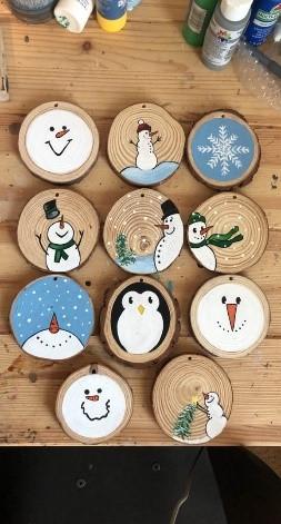 Wood circles decorated with paint and sharpies to show winter objects