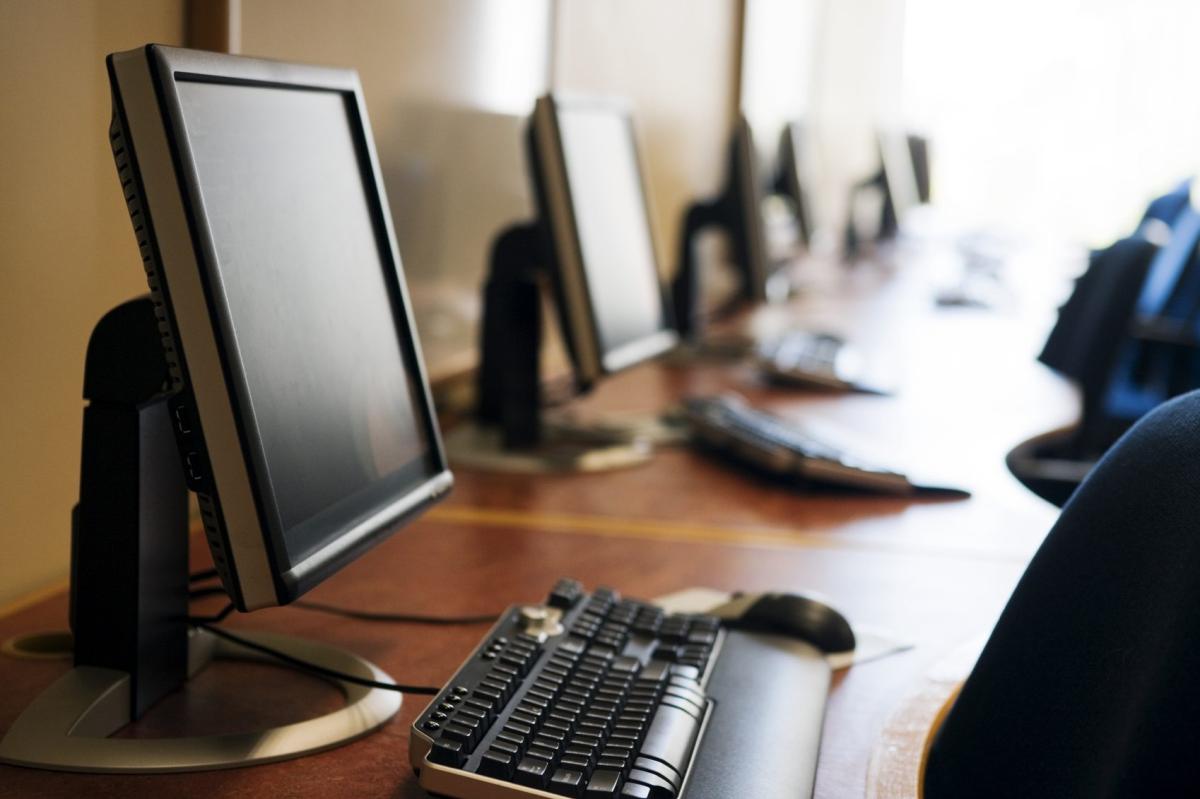 A row of computers on a table