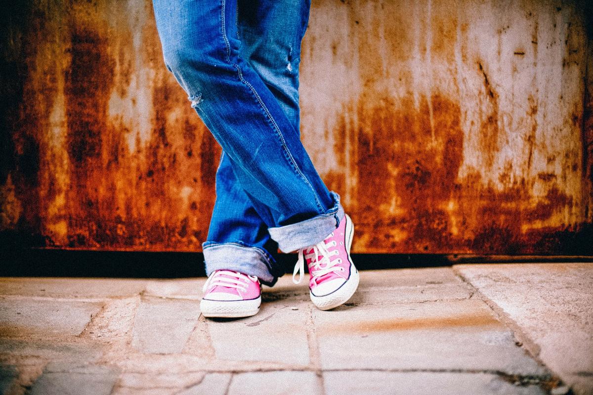 Crossed legs against a wall.