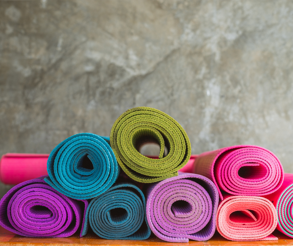 A pile of rolled-up yoga mats