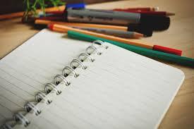 image of opened notebook with pencils