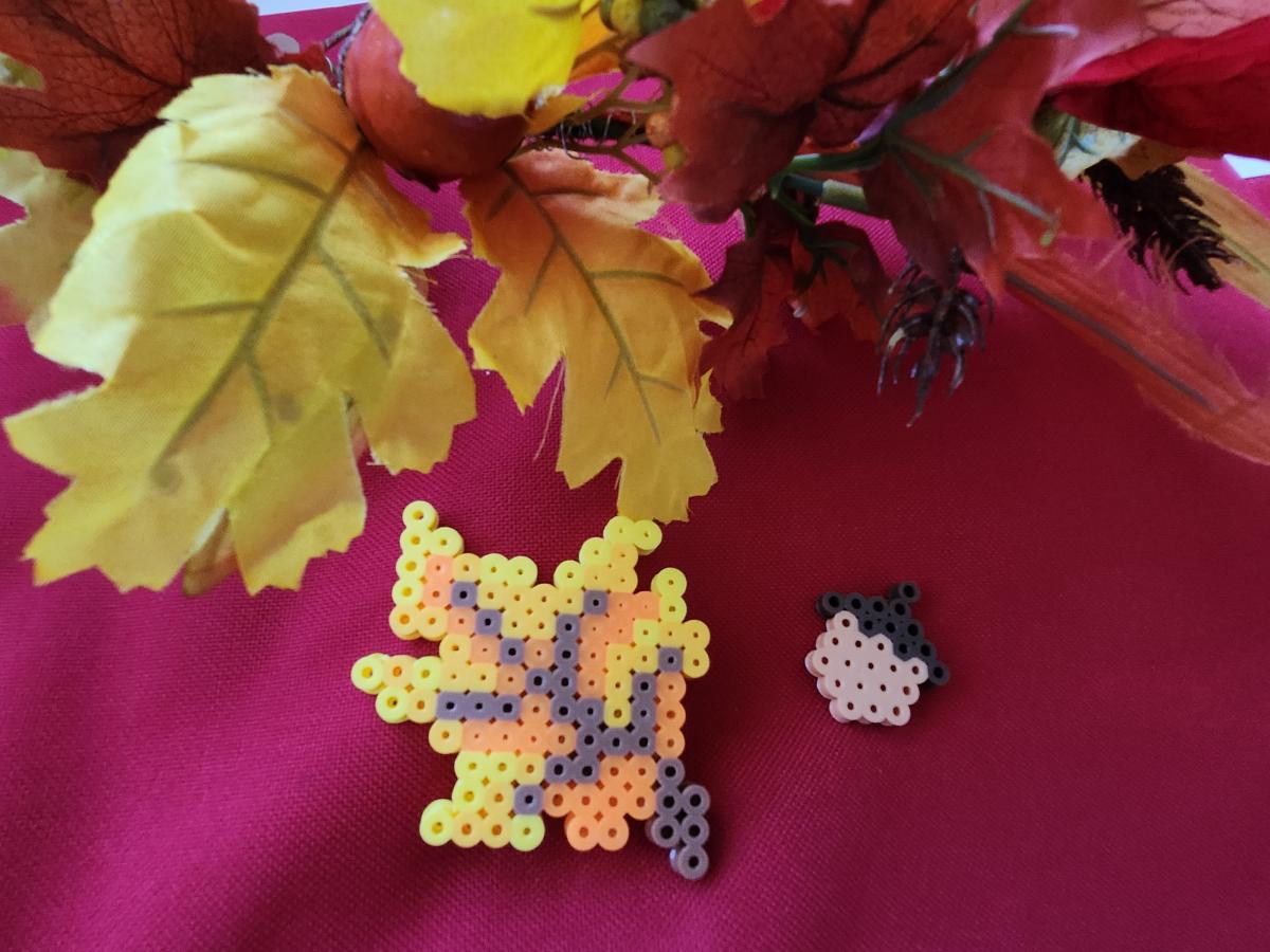 photo of perler bead designs in an orange fall leaf and small acorn