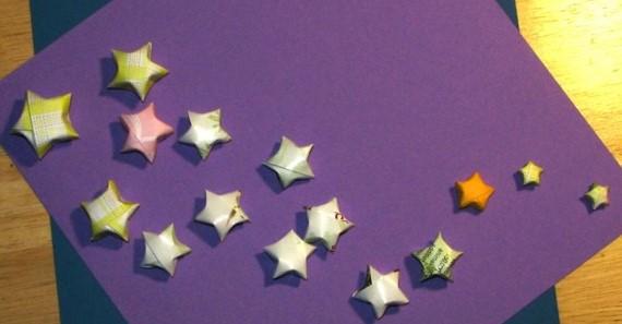 Several small origami stars on a purple background