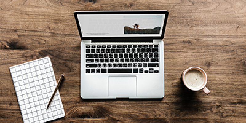 Open laptop on a wooden desk