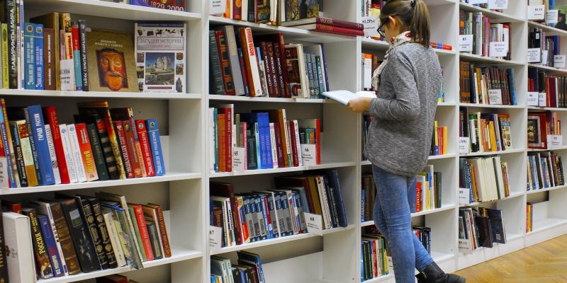 Girl in library stacks