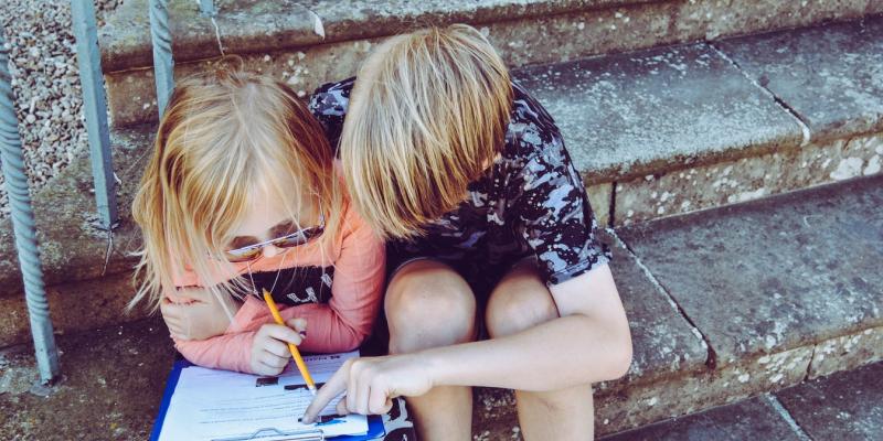 Children on stoop doing homework