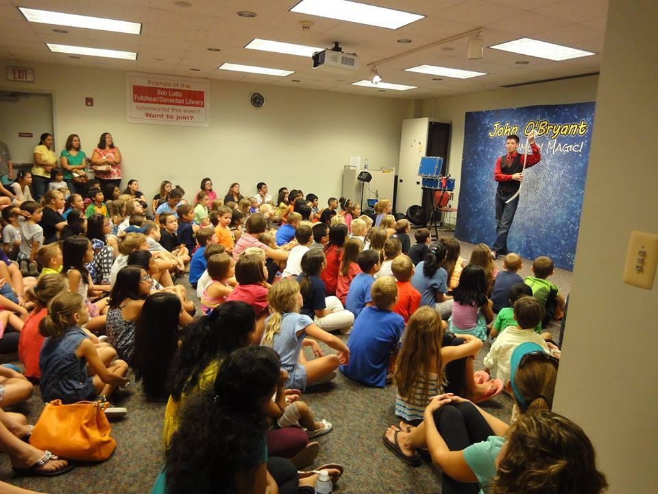 Magician performing for an audience of youth