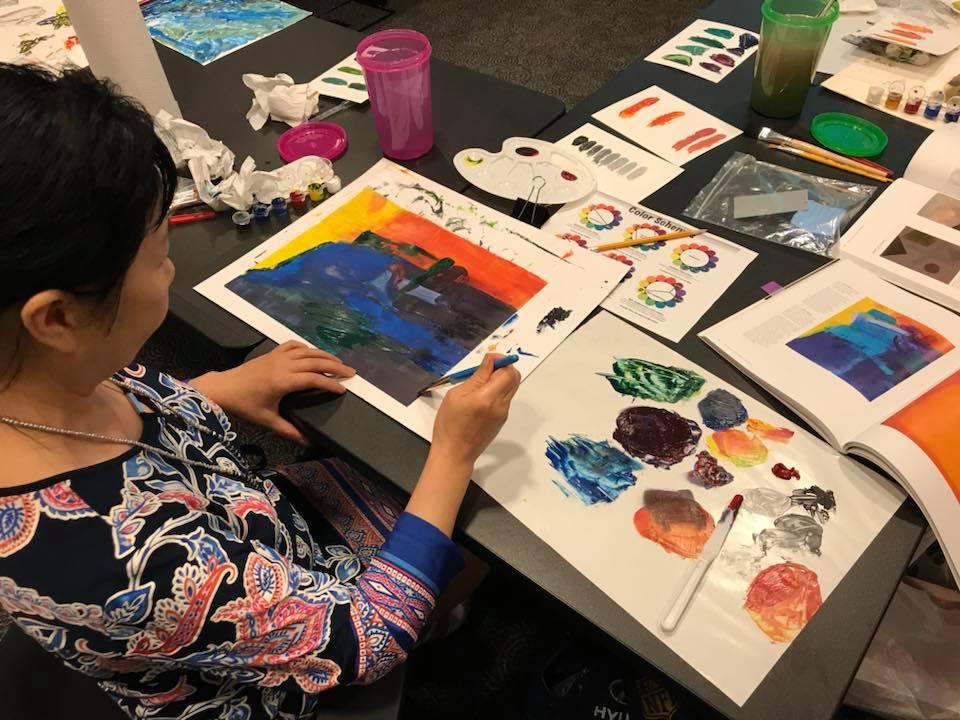 Woman painting during Arts and Crafts event